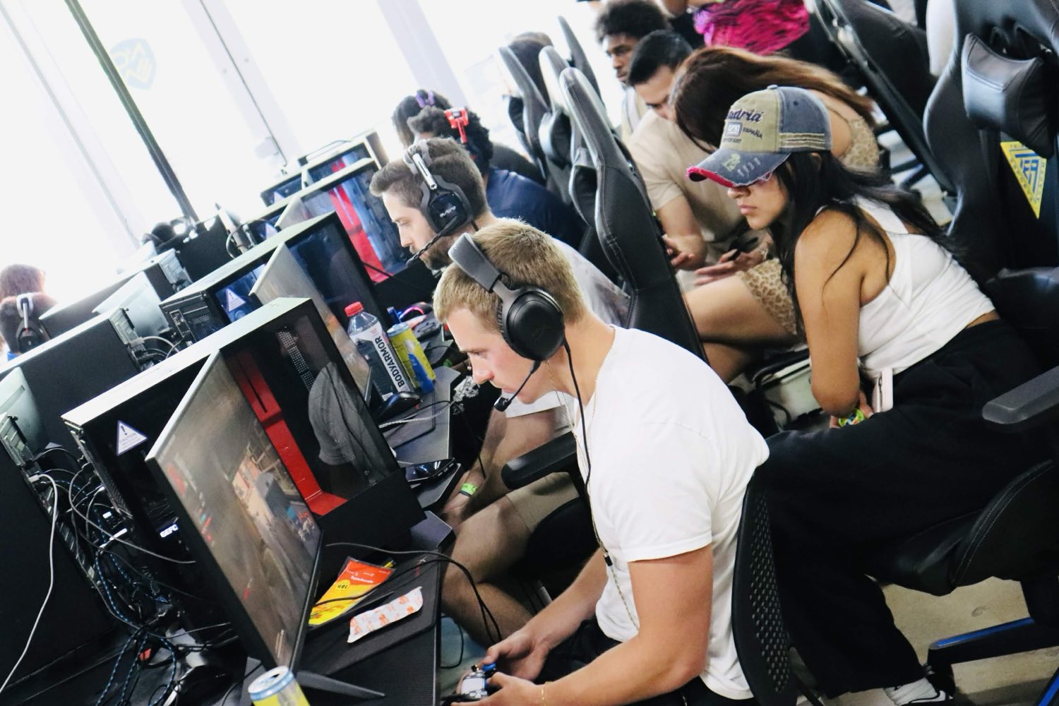 Players competing at their stations wearing headsets
